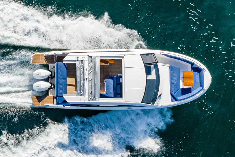 Slide: The Image of 2024 Bavaria Vida 33 yacht cruising on open water, aerial view. - 13