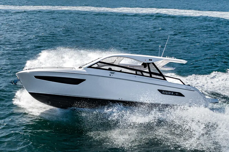 Slide: The Image of 2024 Bavaria Vida 33 yacht cruising on open water, showcasing sleek design and performance. - 15