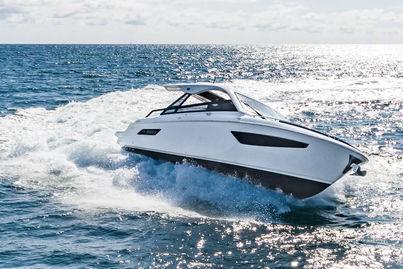 Slide: The Image of 2024 Bavaria Vida 33 yacht cruising on open sea, creating waves. - 18