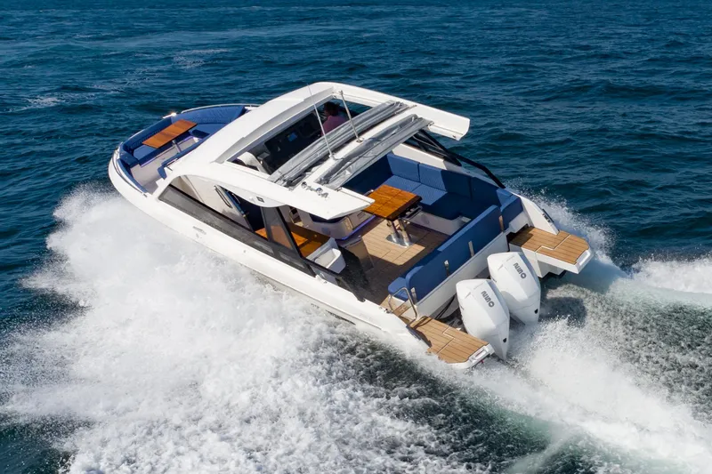 Slide: The Image of 2024 Bavaria Vida 33 yacht cruising on open water, showcasing sleek design and powerful engines. - 2