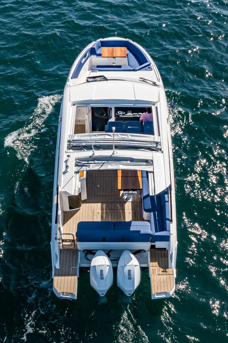 Slide: The Image of 2024 Bavaria Vida 33 boat cruising on open water, aerial view. - 22