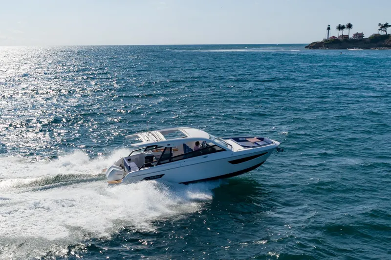 Slide: The Image of 2024 Bavaria Vida 33 yacht cruising on open sea near a coastal lighthouse. - 4