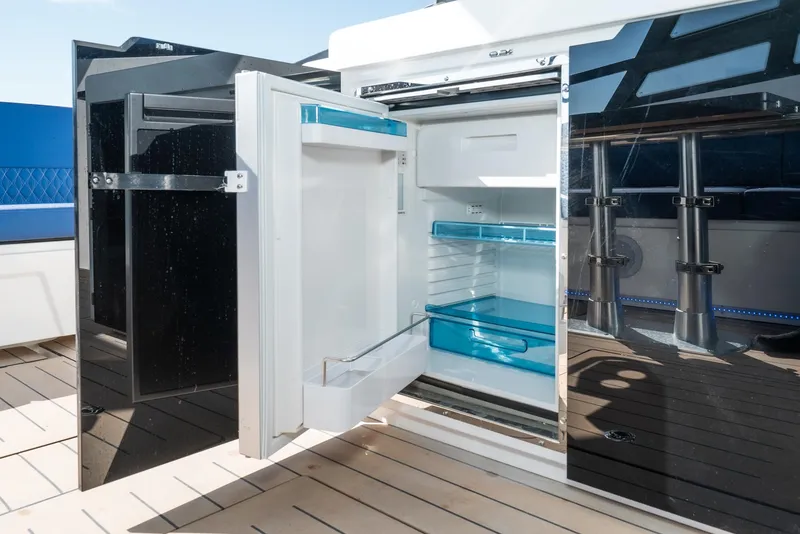 Slide: The Image of Open refrigerator on Bavaria Vida 33 yacht, 2024 model, with sleek black cabinetry. - 41