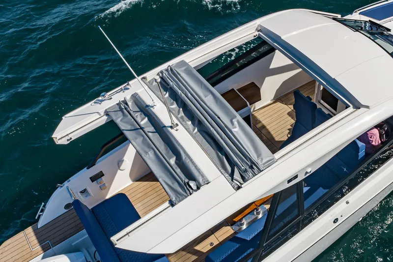 Slide: The Image of 2024 Bavaria Vida 33 yacht with open sunroof cruising on the ocean. - 42