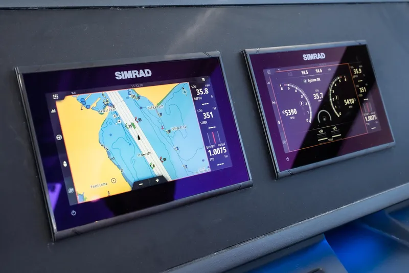 Slide: The Image of Simrad navigation displays on 2024 Bavaria Vida 33 boat dashboard. - 49