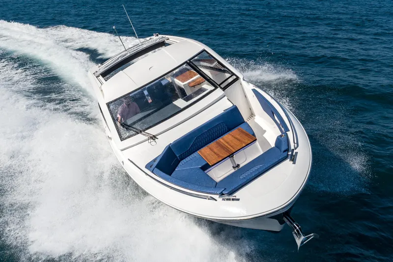 Slide: The Image of 2024 Bavaria Vida 33 motorboat cruising on open water, showcasing sleek design and luxury seating. - 7