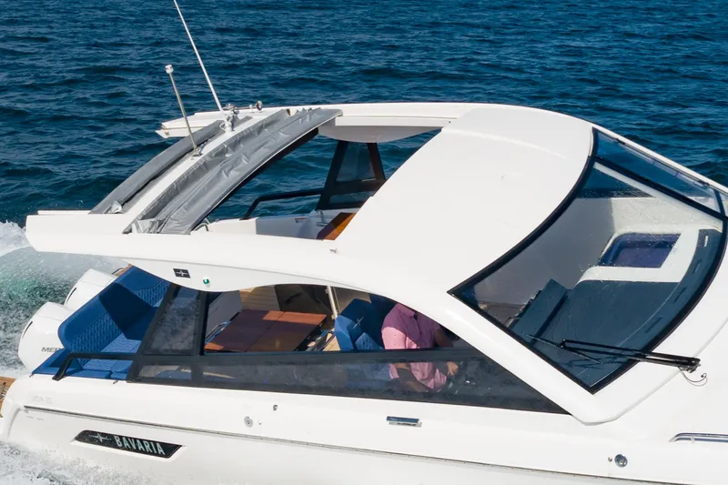 Slide: The Image of 2024 Bavaria Vida 33 yacht cruising on open water, showcasing sleek design and modern features. - 8