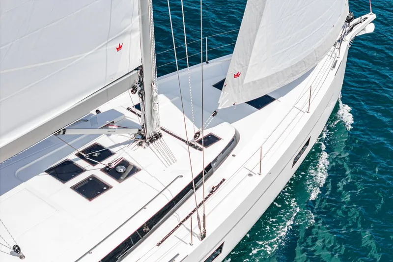 Slide: The Image of 2024 Bavaria C50 yacht sailing on clear blue water, showcasing sleek design and white sails. - 14