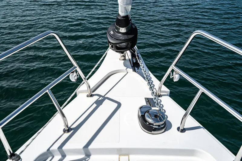 Slide: The Image of Bow of 2024 Bavaria C50 yacht with anchor chain, surrounded by calm water. - 19