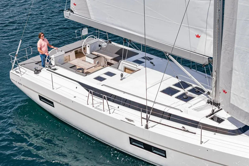 Slide: The Image of 2024 Bavaria C50 sailing yacht on open water, featuring sleek design and spacious deck. - 23