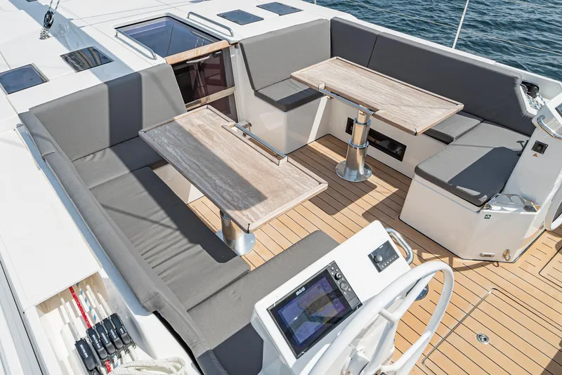 Slide: The Image of 2024 Bavaria C50 yacht cockpit with seating, tables, and navigation controls. - 31