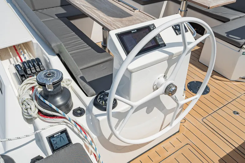 Slide: The Image of 2024 Bavaria C50 yacht helm with modern navigation equipment and teak deck. - 32