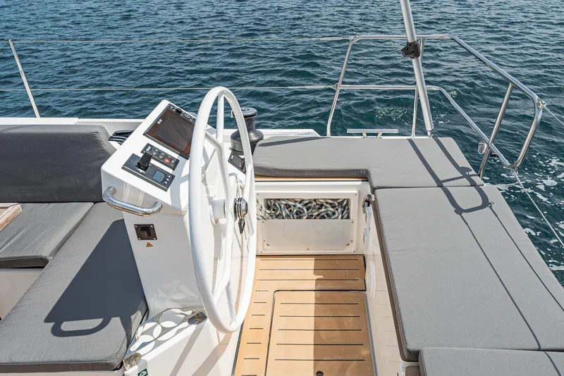Slide: The Image of 2024 Bavaria C50 yacht helm with modern controls and comfortable seating, overlooking the ocean. - 37