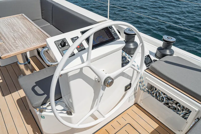 Slide: The Image of 2024 Bavaria C50 yacht helm with modern controls and seating on teak deck. - 38