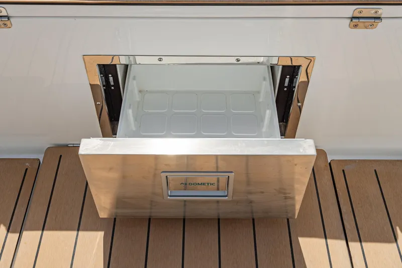 Slide: The Image of 2024 Bavaria C50 yacht with open Dometic drawer fridge on deck. - 40