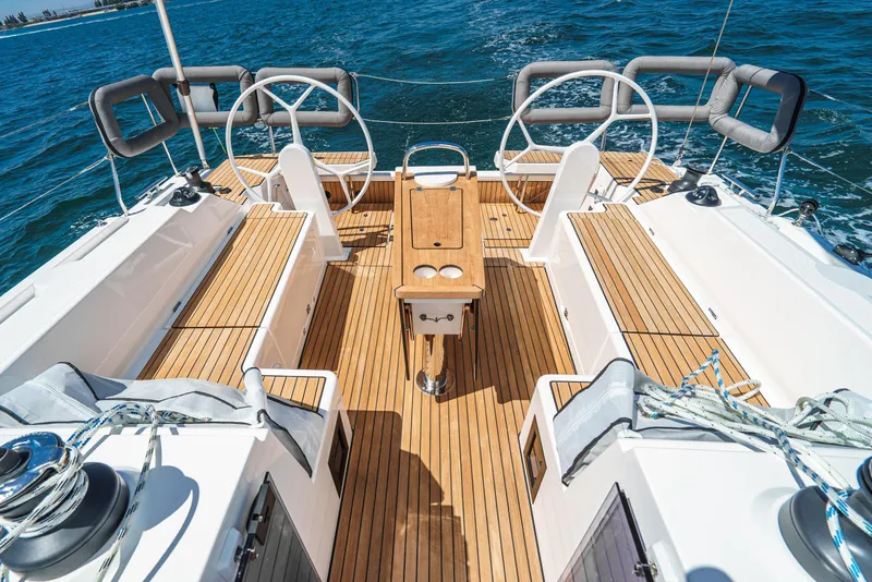 Slide: The Image of 2024 Bavaria C42 sailboat cockpit with dual steering wheels and teak decking. - 14