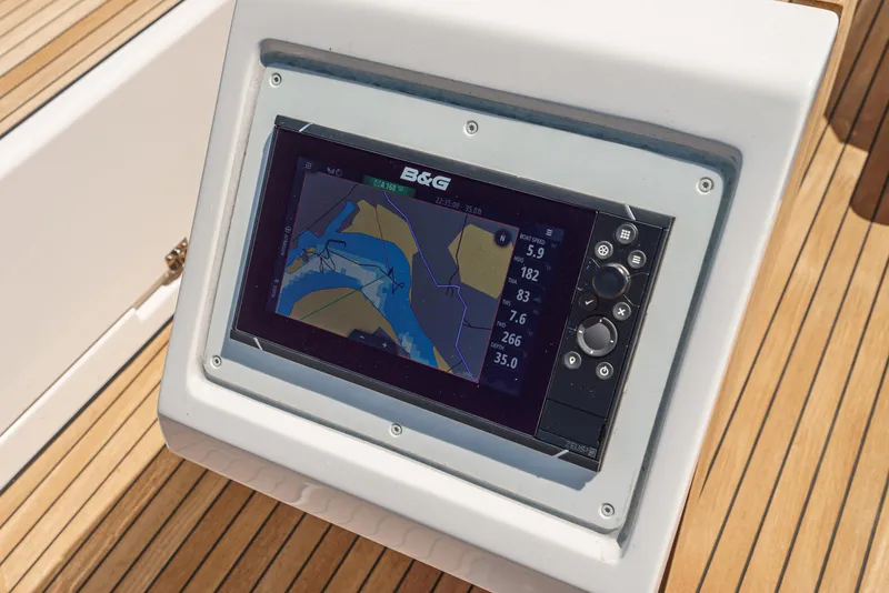 Slide: The Image of Bavaria C42 2024 yacht navigation system on wooden deck. - 18