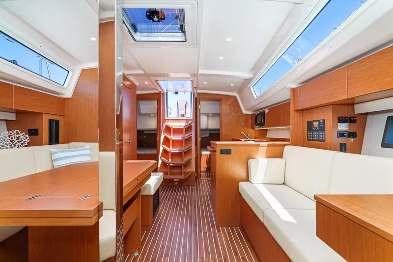 Slide: The Image of Luxurious interior of 2024 Bavaria C42 yacht, featuring modern wood finishes and spacious seating. - 24