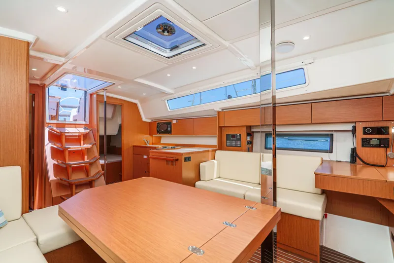 Slide: The Image of 2024 Bavaria C42 yacht interior with modern wood finish and spacious seating area. - 29
