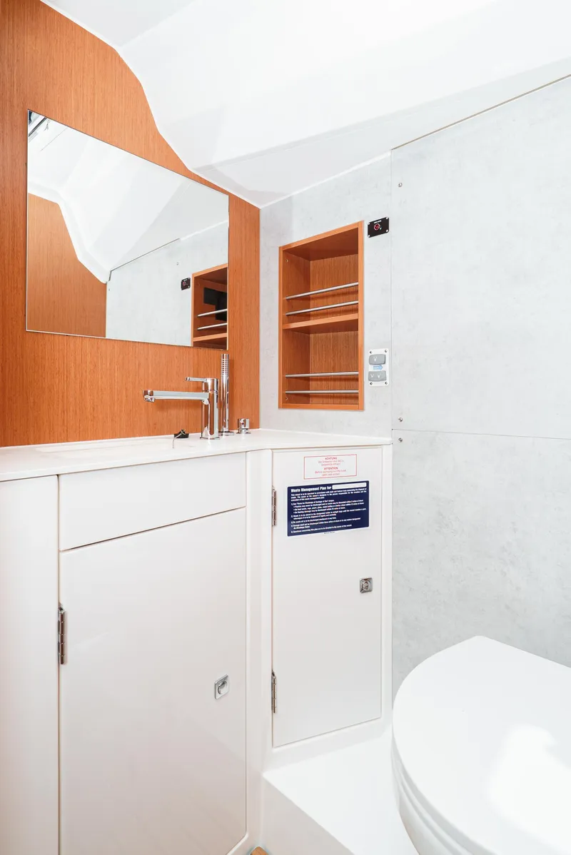 Slide: The Image of 2024 Bavaria C42 yacht bathroom with modern fixtures and wooden accents. - 37