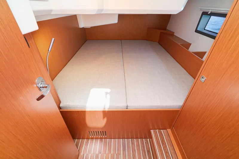 Slide: The Image of 2024 Bavaria C42 yacht cabin with wooden interior and comfortable bed. - 40