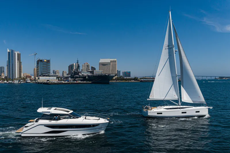 Slide: The Image of 2024 Bavaria C42 sailboat on water with city skyline in background. - 45