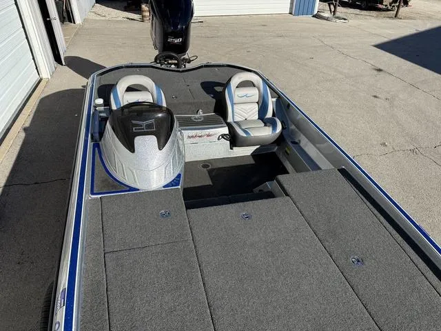 Slide: The Image of 2015 Legend V20 boat with dual seats and motor, parked on concrete. - 15