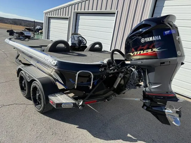 Slide: The Image of 2015 Legend V20 boat with Yamaha VMAX engine parked near storage units. - 2