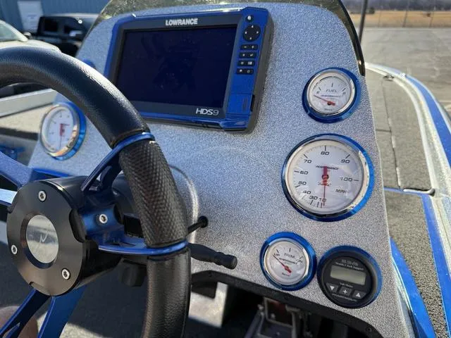 Slide: The Image of Steering wheel and dashboard of a 2015 Legend V20 boat with Lowrance HDS9 display. - 22