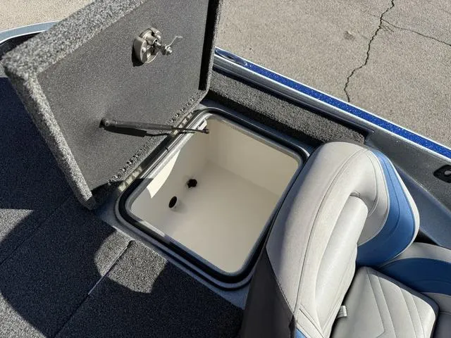 Slide: The Image of Open storage compartment in 2015 Legend V20 boat, next to a cushioned seat. - 25