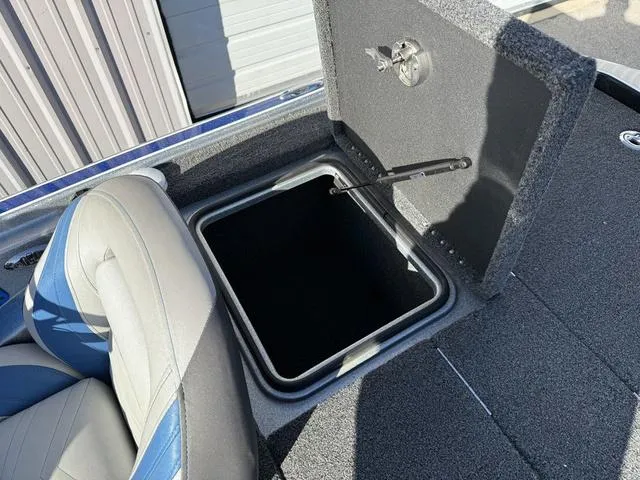 Slide: The Image of 2015 Legend V20 boat storage compartment with open lid and adjacent seat. - 26