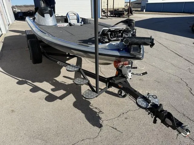 Slide: The Image of 2015 Legend V20 boat on trailer, parked outdoors in a sunny area. - 6