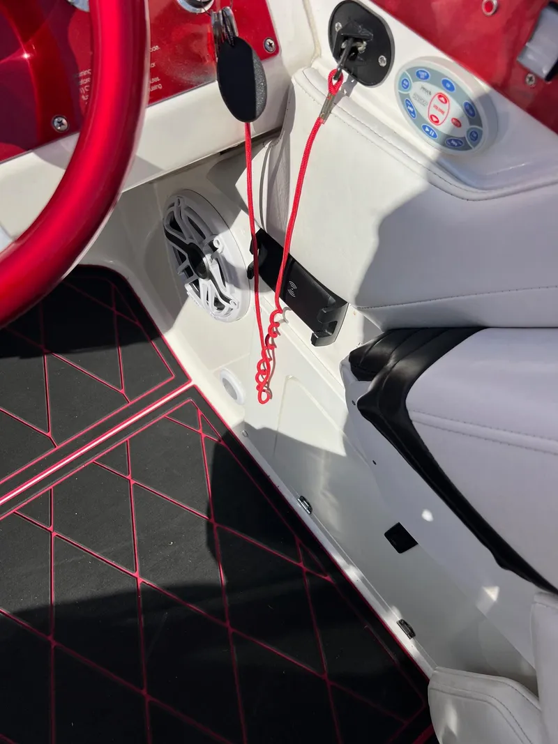 Slide: The Image of 2004 Fountain 29 Fever boat interior with red accents and control panel. - 13