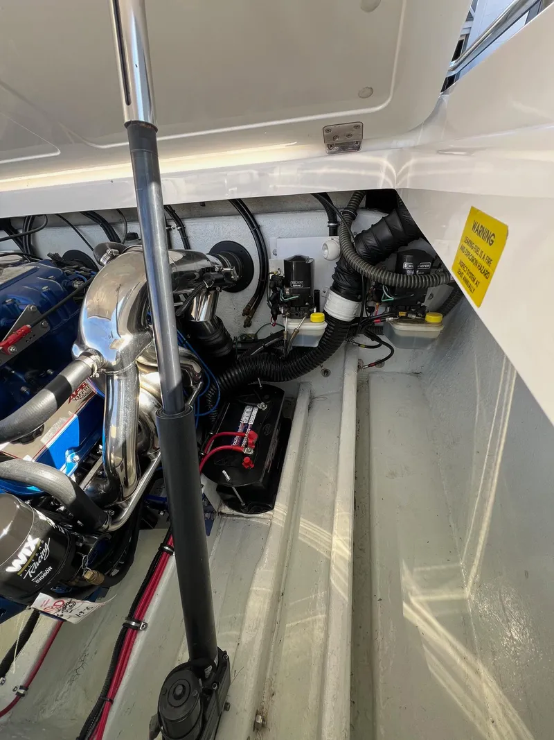 Slide: The Image of Engine compartment of a 2004 Fountain 29 Fever boat, showcasing mechanical components and wiring. - 17