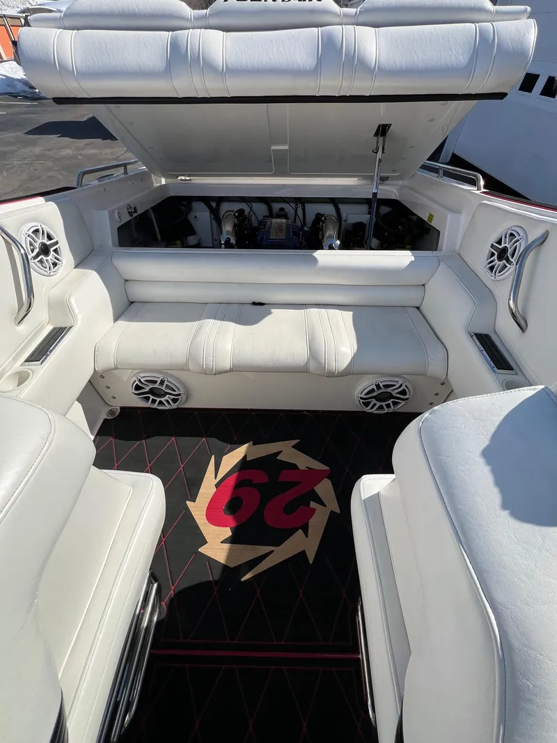 Slide: The Image of 2004 Fountain 29 Fever boat interior with white seating and open engine compartment. - 19