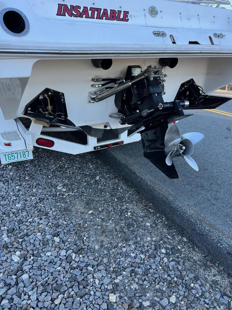 Slide: The Image of 2004 Fountain 29 Fever boat stern with propeller on gravel surface. - 3