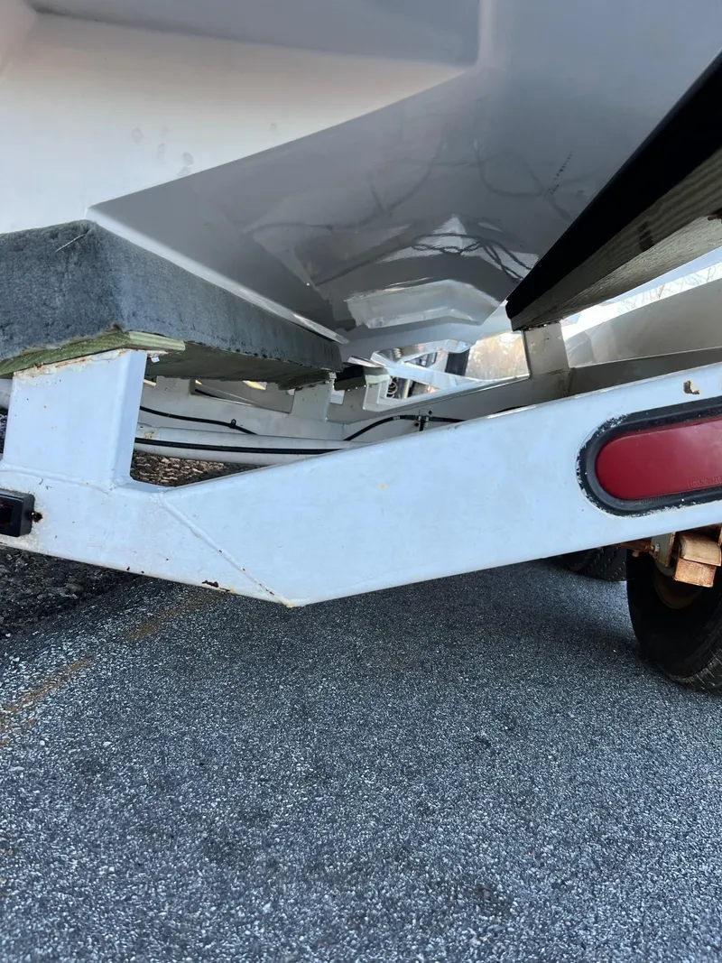 Slide: The Image of Close-up of a 2004 Fountain 29 Fever boat trailer on asphalt. - 8