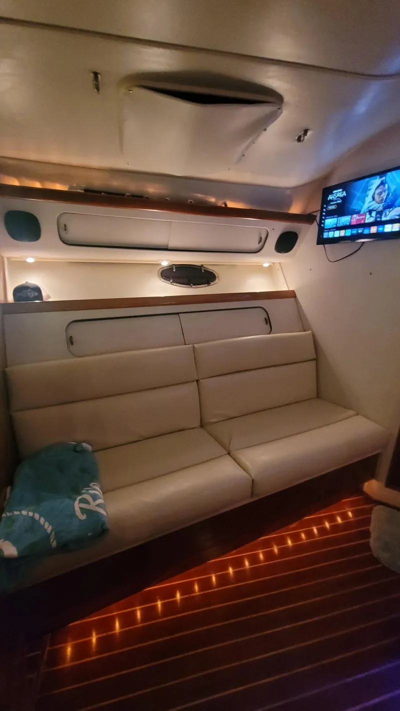 Slide: The Image of Interior of 1992 Tiara Yachts 36 Open with cozy seating and ambient lighting. - 11