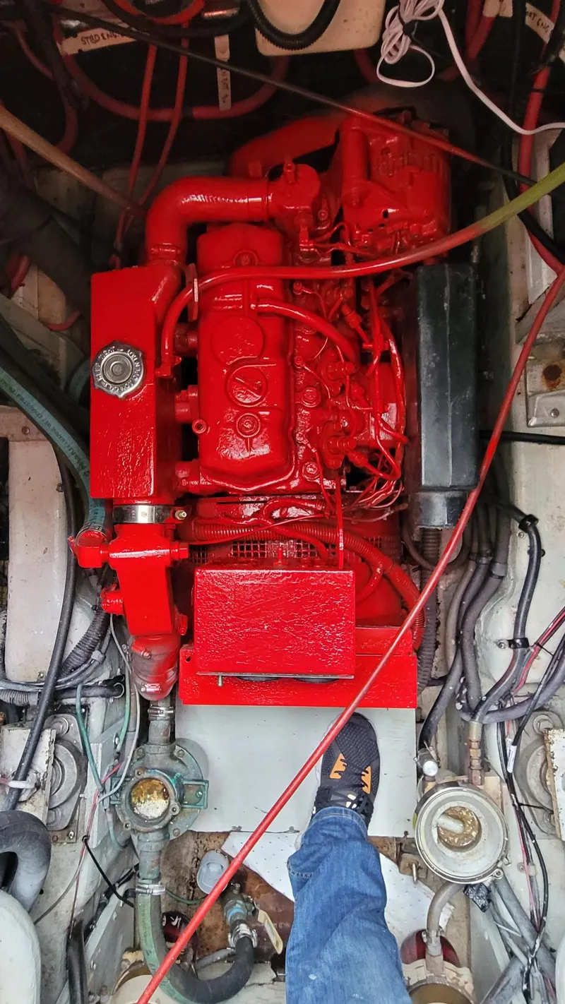 Slide: The Image of Engine compartment of a 1992 Tiara Yachts 36 Open, featuring a red-painted engine. - 14