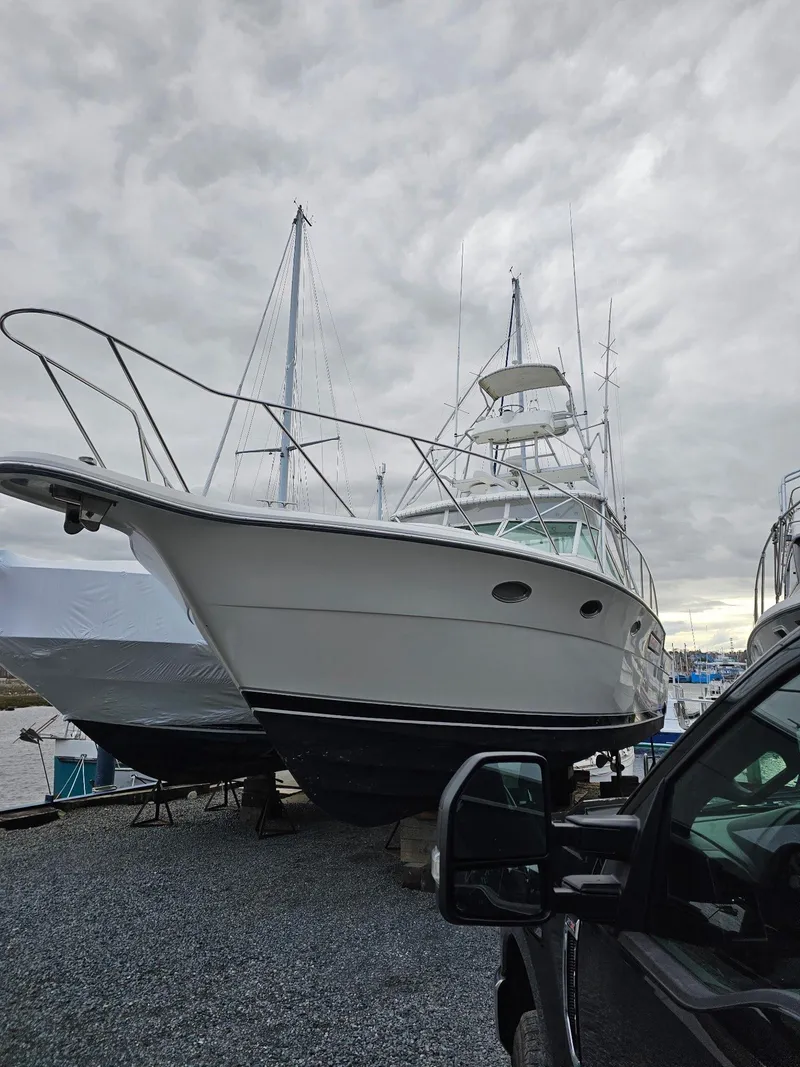 Slide: The Image of 1992 Tiara Yachts 36 Open boat on dry dock under cloudy skies. - 2