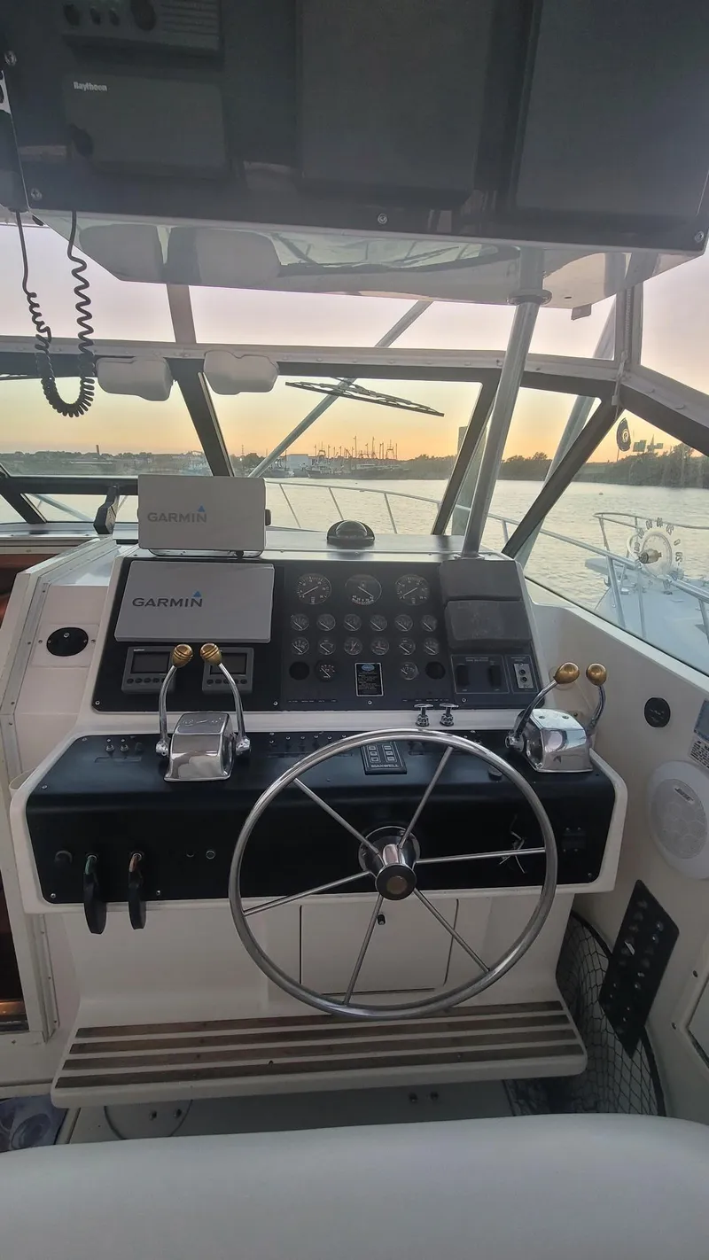 Slide: The Image of 1992 Tiara Yachts 36 Open helm with Garmin navigation, sunset view in background. - 3