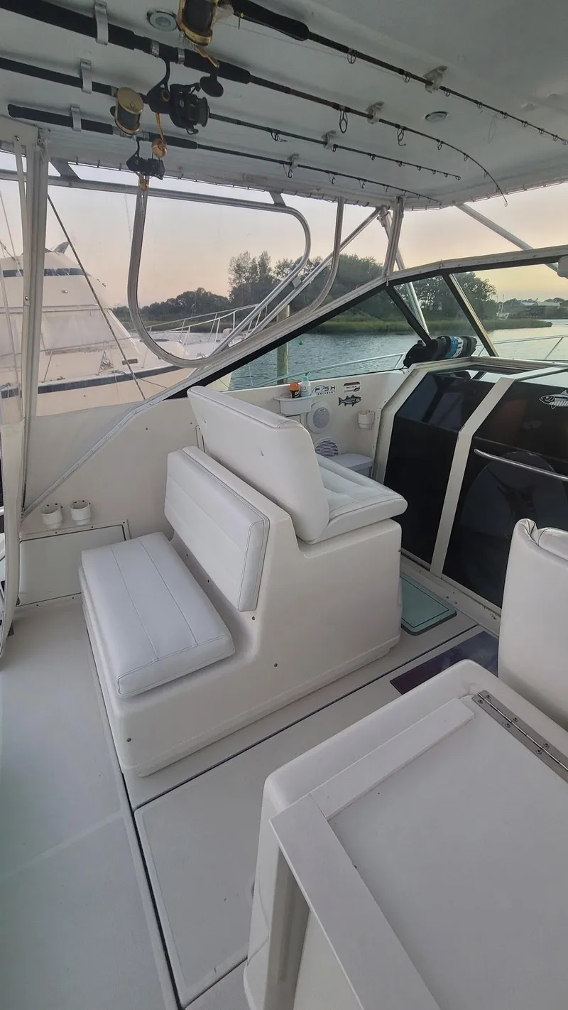Slide: The Image of 1992 Tiara Yachts 36 Open interior with seating and fishing rods. - 5