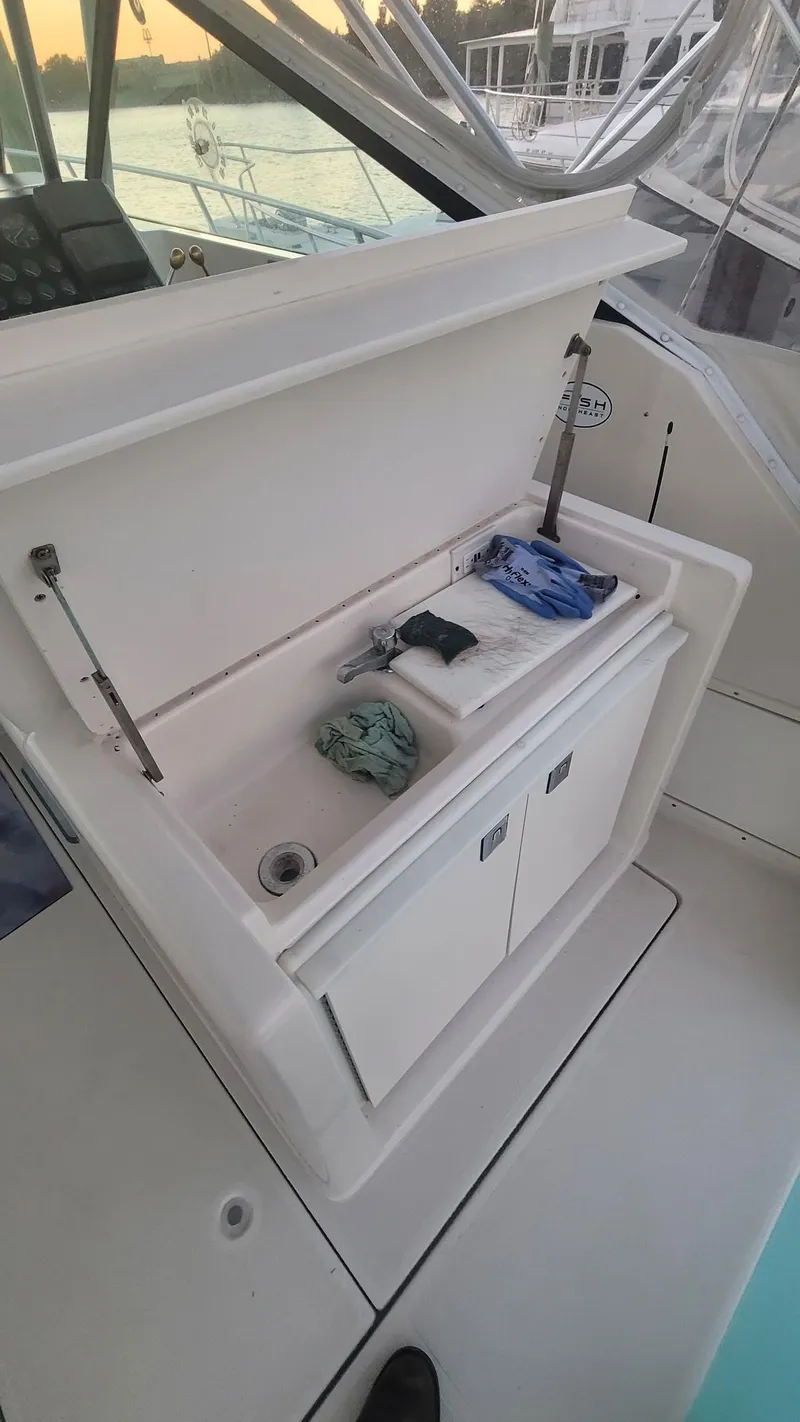 Slide: The Image of 1992 Tiara Yachts 36 Open boat sink area with storage and cleaning supplies. - 6