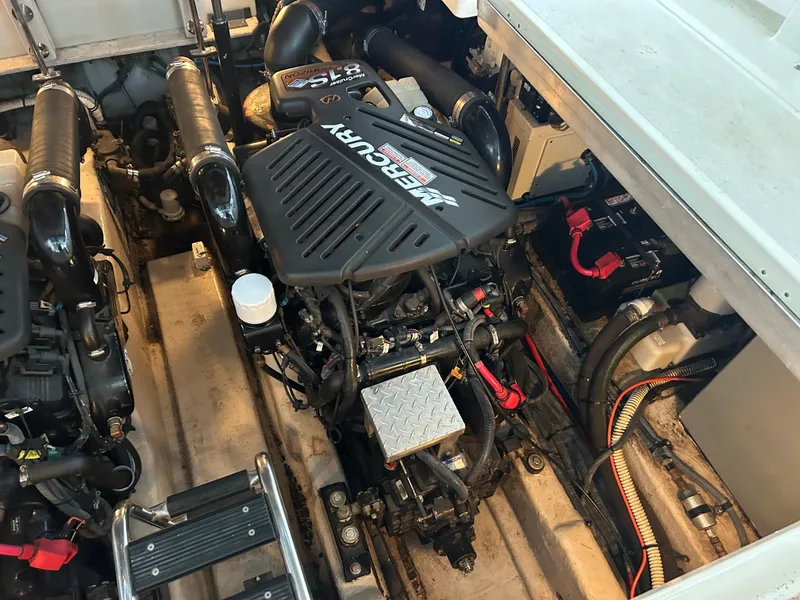 Slide: The Image of Engine compartment of a 2004 Sea Ray 420 Sundancer with Mercury engine components. - 11