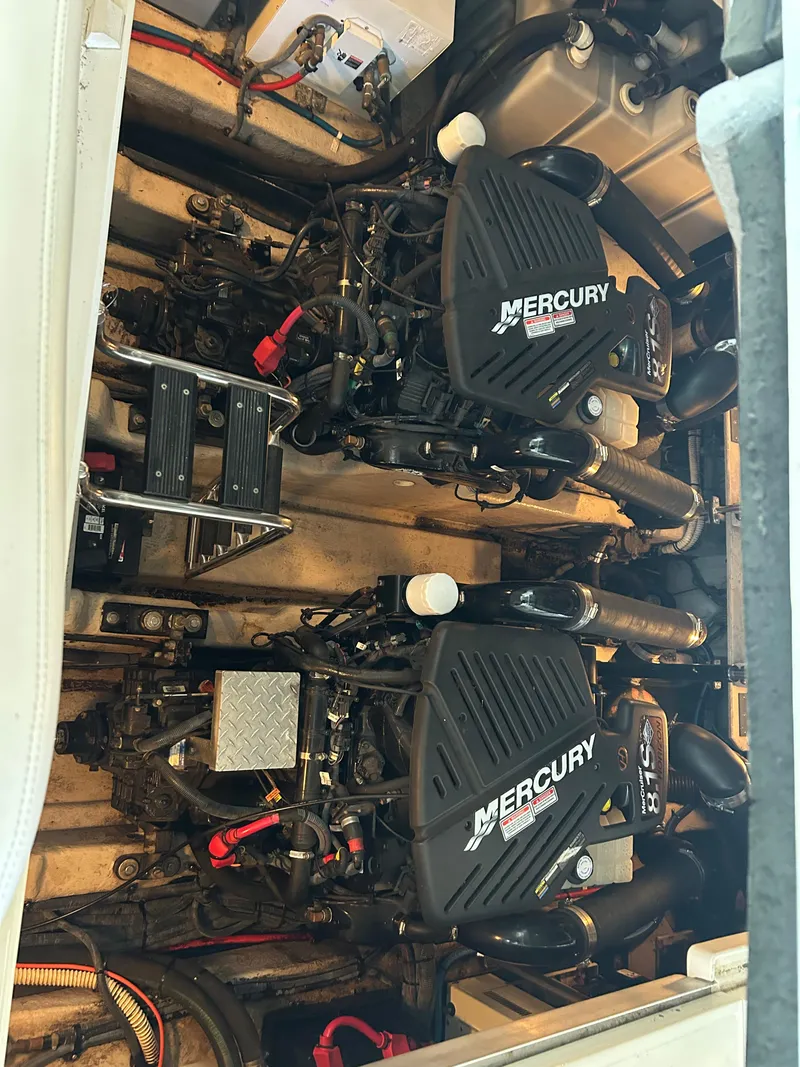 Slide: The Image of Engine compartment of a 2004 Sea Ray 420 Sundancer with twin Mercury engines. - 13