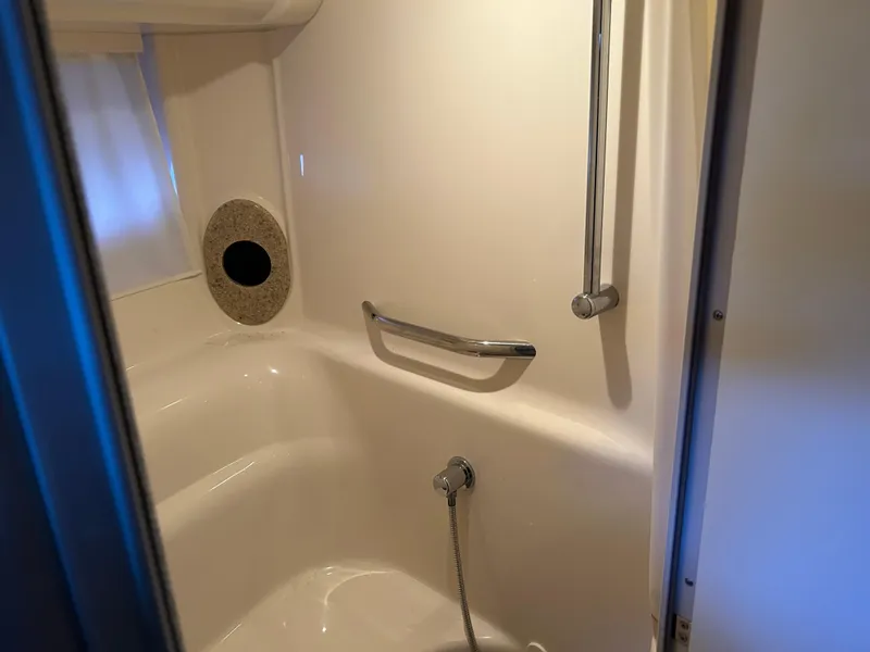 Slide: The Image of Bathroom interior of 2004 Sea Ray 420 Sundancer yacht, featuring shower and grab bar. - 14