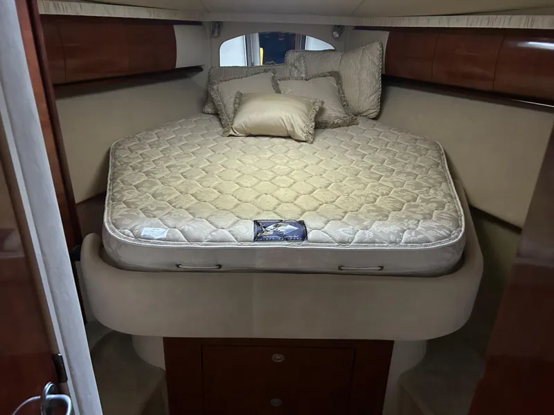Slide: The Image of 2004 Sea Ray 420 Sundancer cabin with a cozy bed and elegant wood finish. - 18