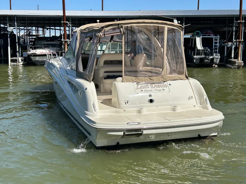 Slide: The Image of 2004 Sea Ray 420 Sundancer boat docked in marina, rear view. - 2