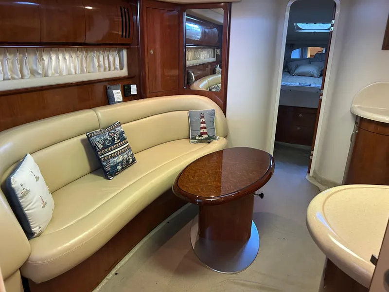 Slide: The Image of Interior of 2004 Sea Ray 420 Sundancer yacht with elegant seating and table. - 20