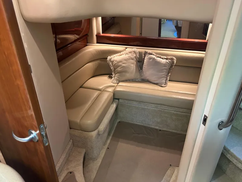 Slide: The Image of 2004 Sea Ray 420 Sundancer interior with beige leather seating and decorative pillows. - 22